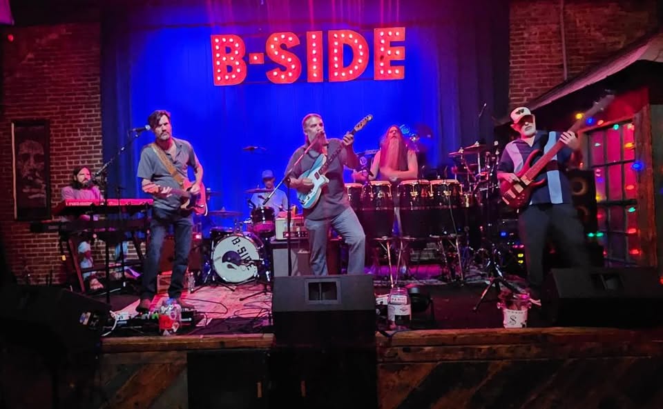 Proving Ground performing live at B-SIDE Memphis — the full six-piece band on stage with the iconic B-SIDE sign